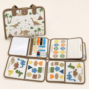 A children's fabric activity and learning bag shown both closed and open on a light beige background. The closed view shows dinosaur illustrations with brown handles and a snap closure.